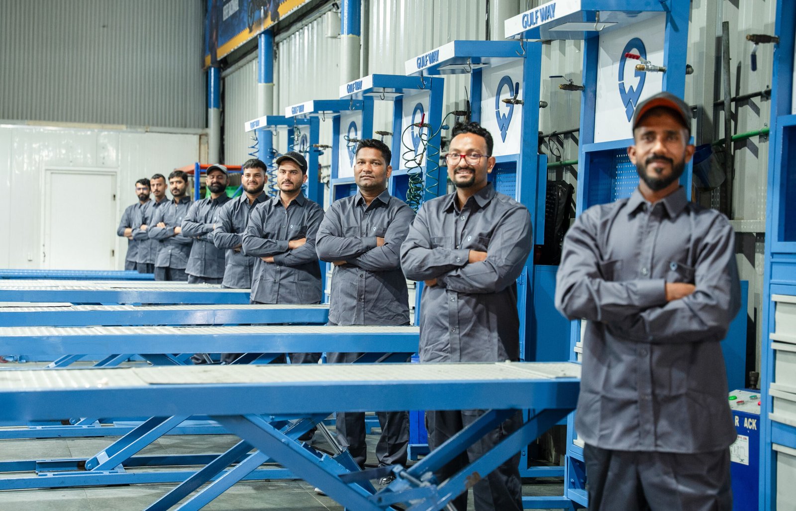 Gulf Way Auto Services mechanics standing at workstations before starting bike repair services